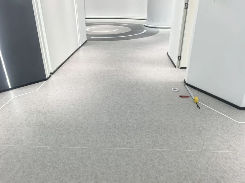 PVC sheet flooring sealed around a floor drain